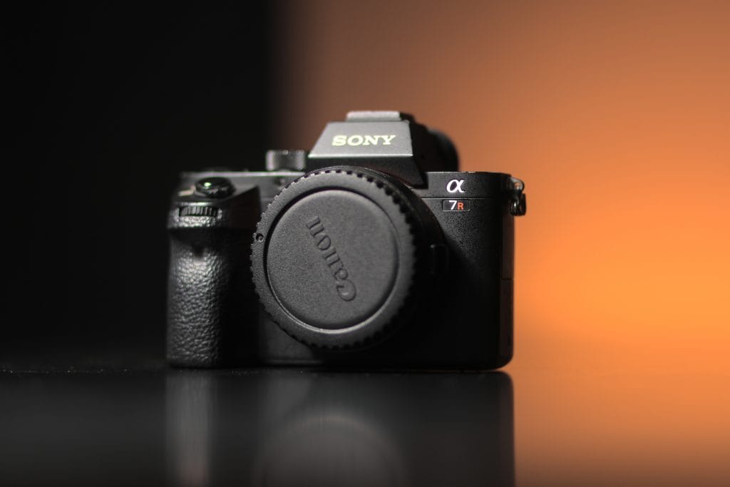 Sony a7R ii mirrorless camera sitting on a reflective surface