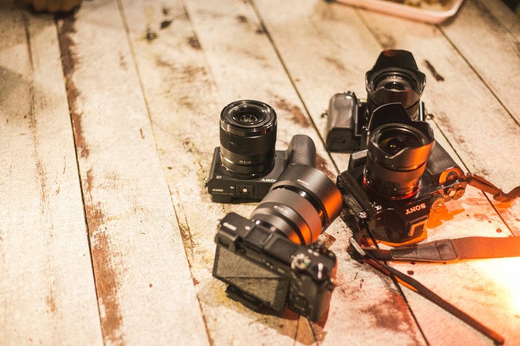 Sony cameras laying on wood floor
