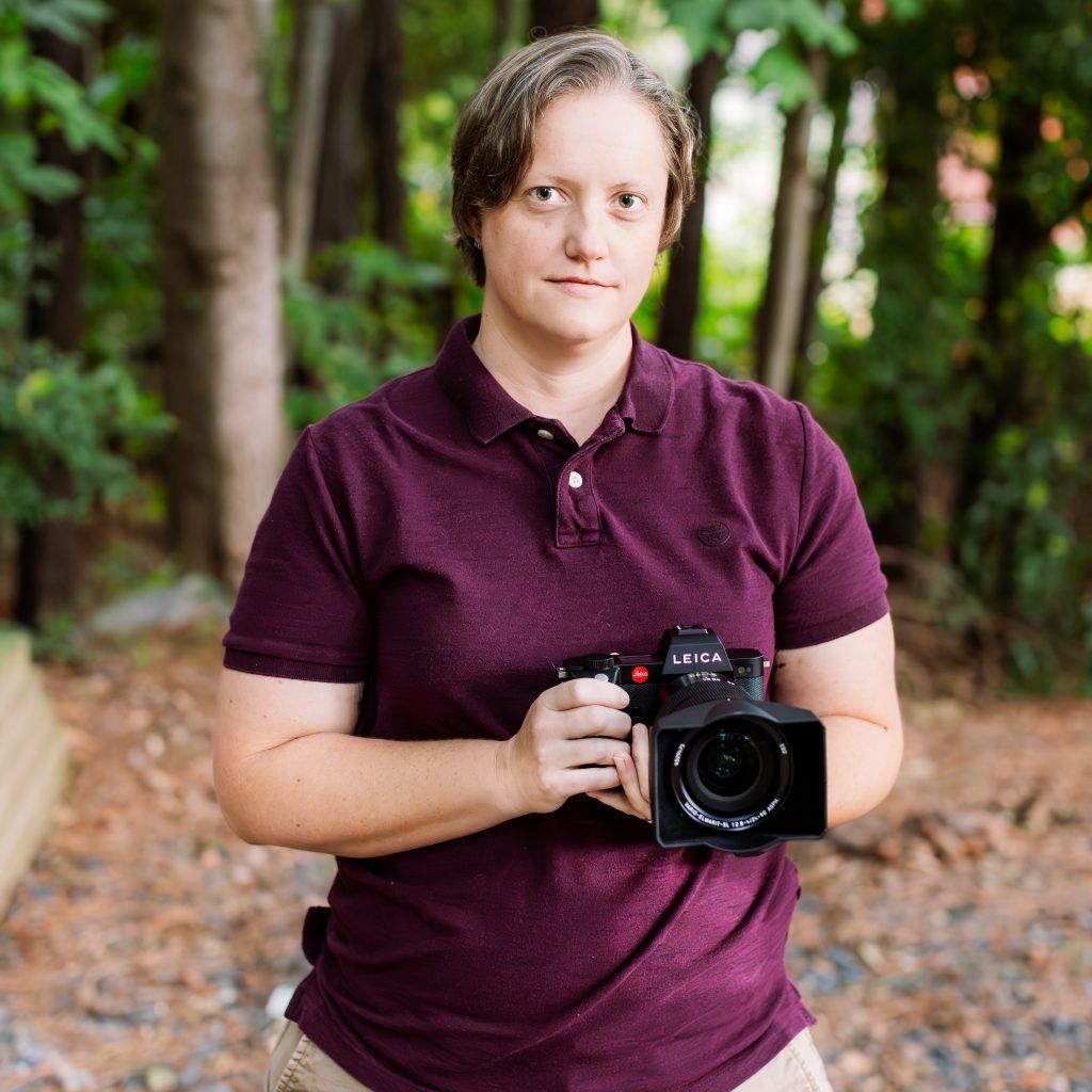 Headshot of KEH staff member Jena holding a Leica SL2.