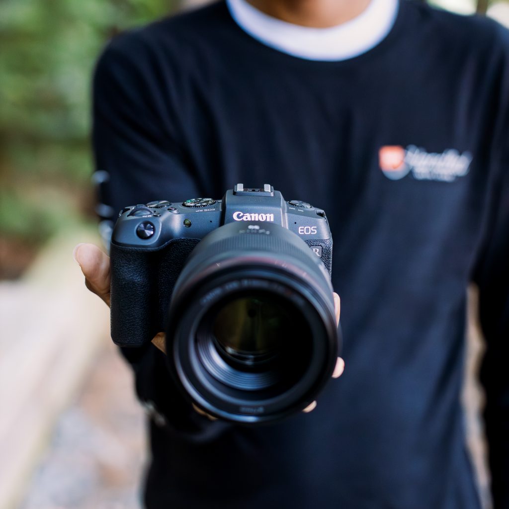 Close-up of Canon EOS RP being held by KEH staff member Keith.