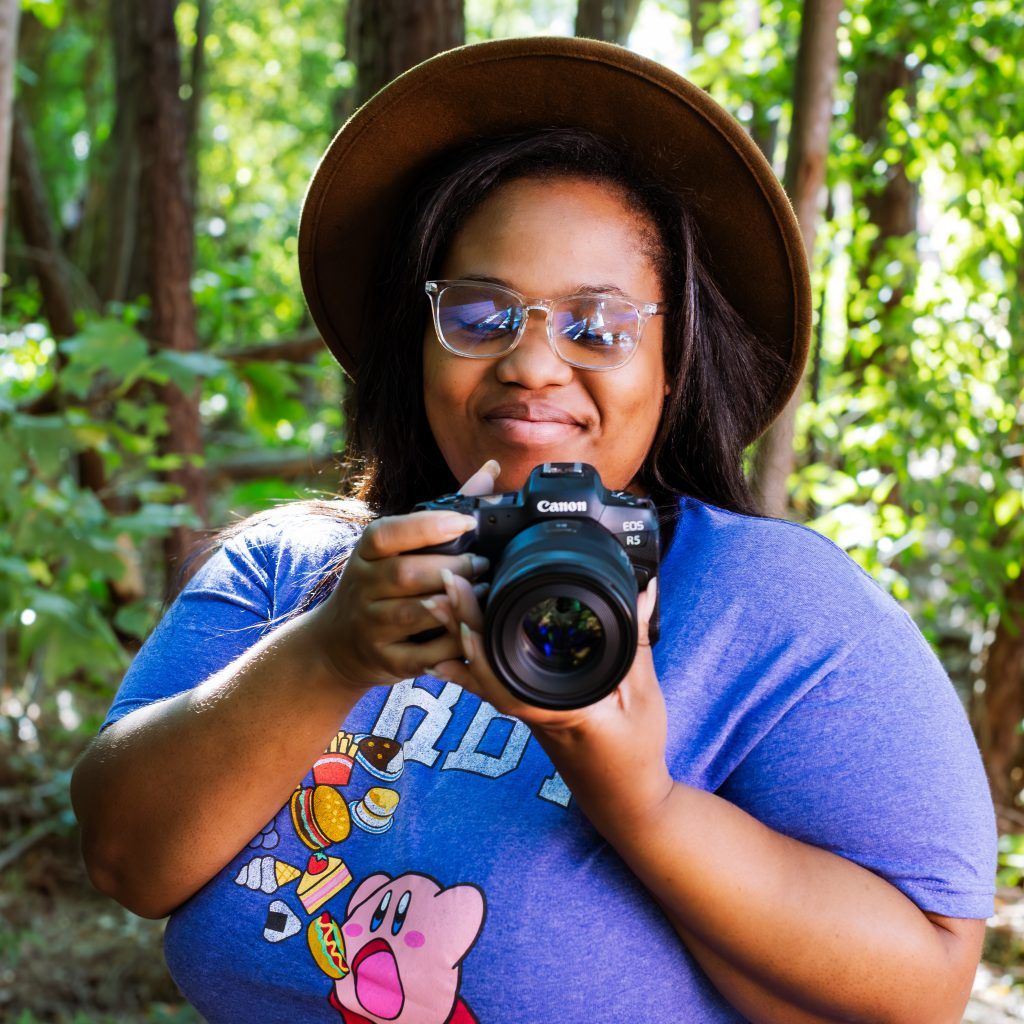 KEH staff member Constance Glenn looking down at her Canon EOS R5 camera.