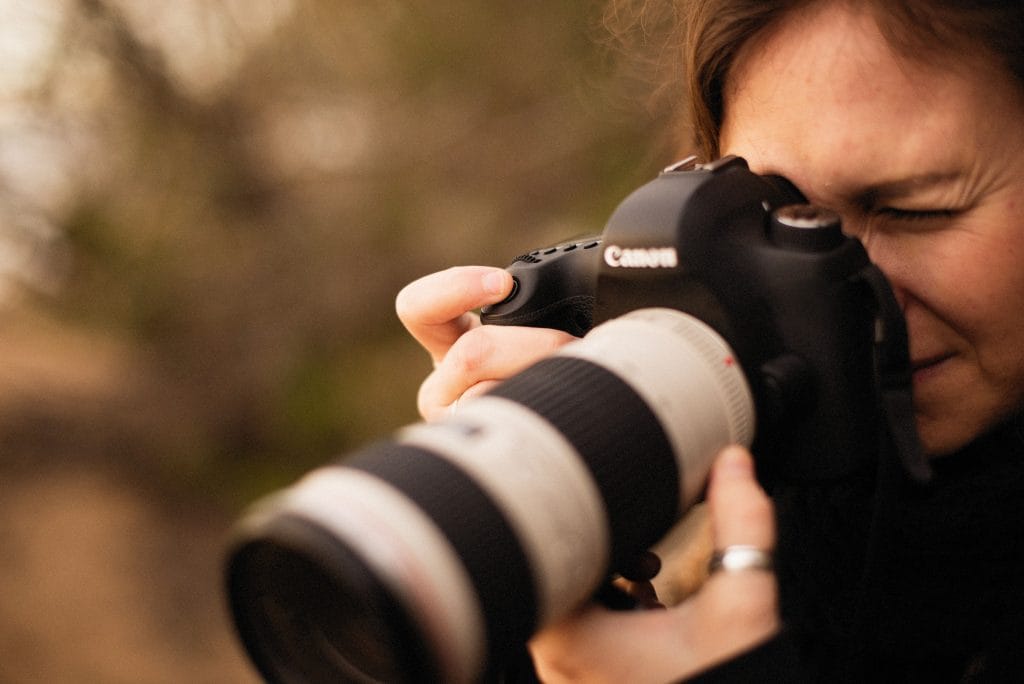 Wildlife photographer using Canon camera with long lens
