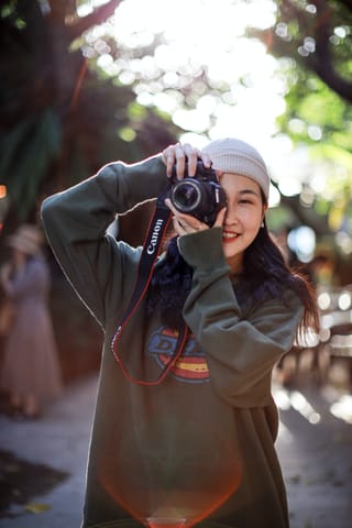 Smiling girl with Canon camera
